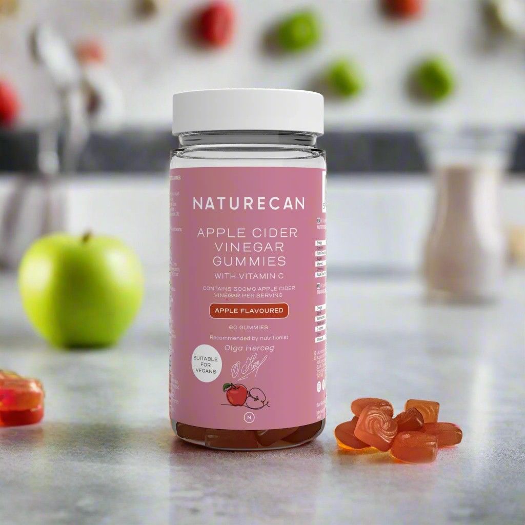 Naturecan Apple Cider Vinegar Gummies bottle on a table with gummies and apples in the background
